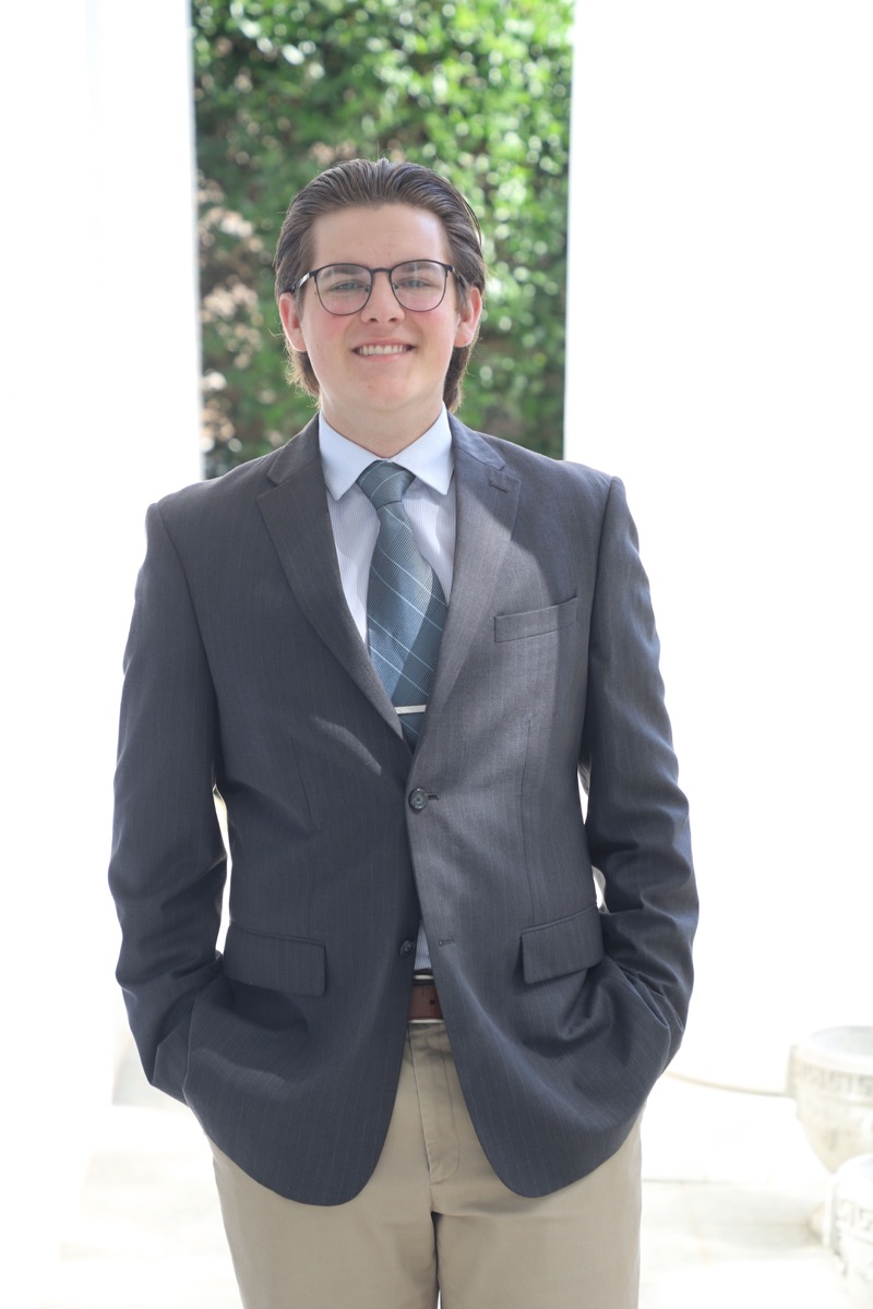 Caden Whitt, founder of WhittWorks Studios, in a grey suit